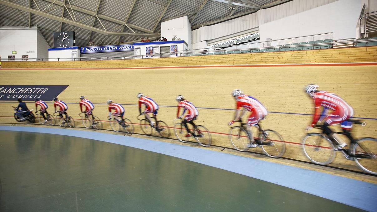 Cyclists going round a velodrome